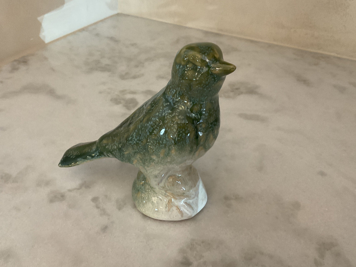 Glazed ceramic bird figurine standing