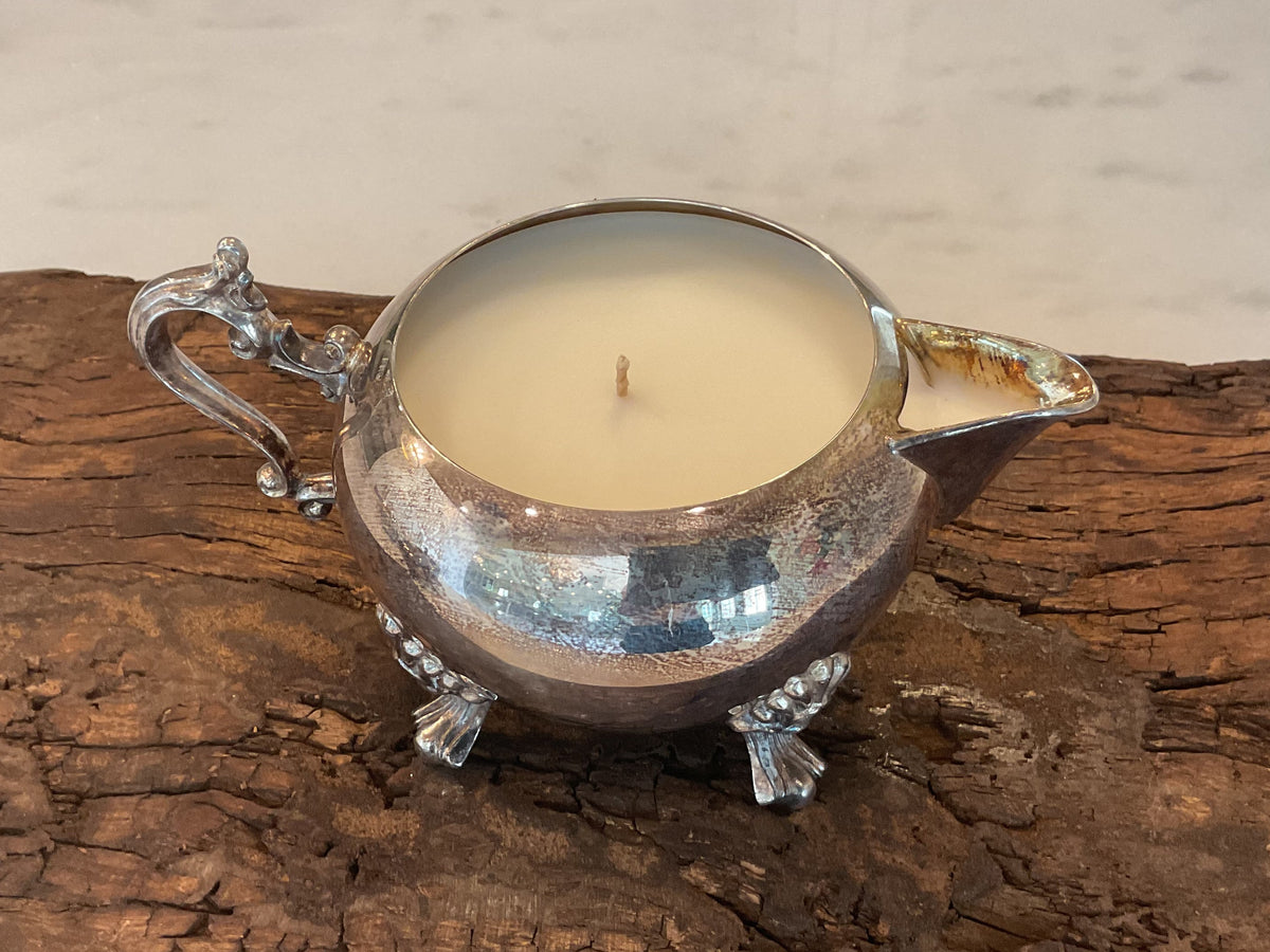 Antique silver candle vessel with legs and spout